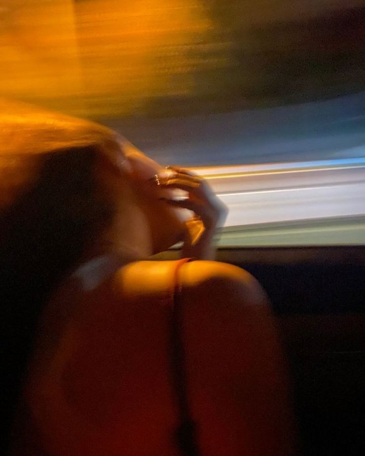 blurred photo of girl head out the window late night drive
